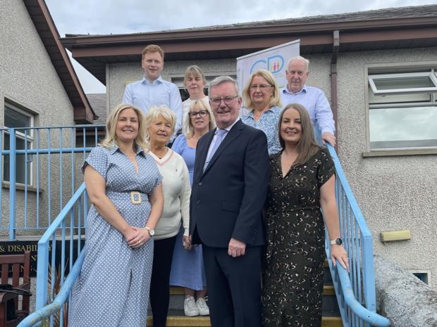 Health Minister Mike Nesbitt with GPs, practice staff and family members at Rathkeeland House Surgery, Crossmaglen