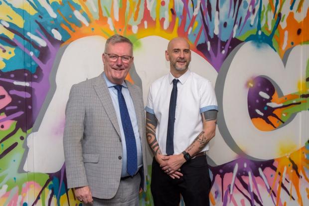 Health Minister Mike Nesbitt pictured with Gary Rutherford with decorative background