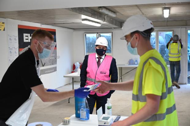 Health Minister Robin Swann during a visit to the EH Allingham Construction site on the Crumlin Rd Belfast, one of the employer led Assisted Testing Sites in operation in NI
